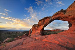 View of Broken Arch during golden hour in Arches National Park