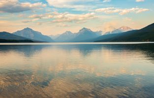 Lake McDonald in Glacier National Park moments before sunset, with the mountains visible in the background