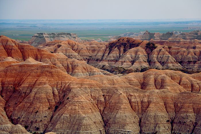 An aerial view of the Badlands National Park during a hot and dry day